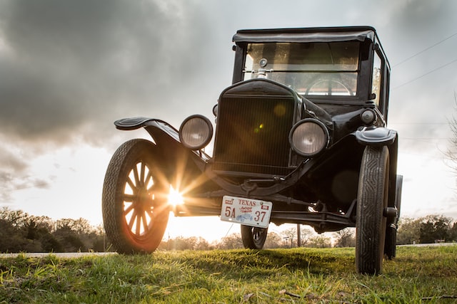 vintage black car on green grass
