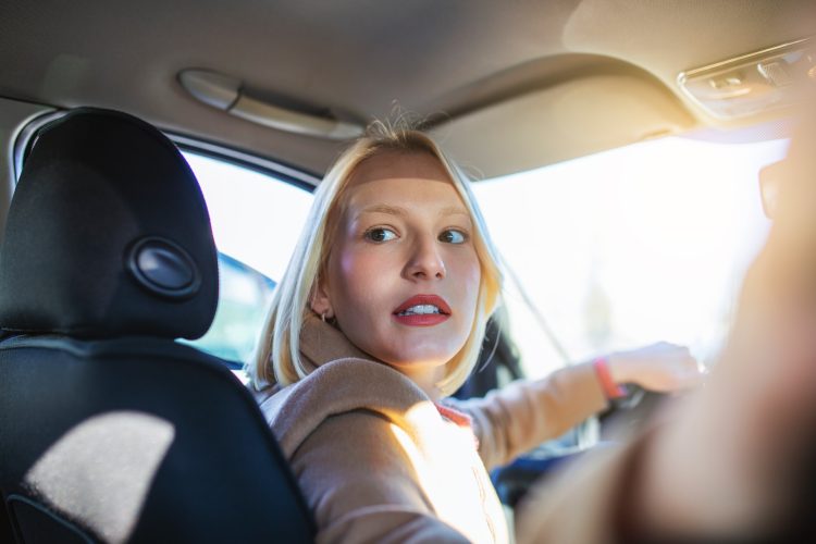 woman in car indoor turning around looking at passengers