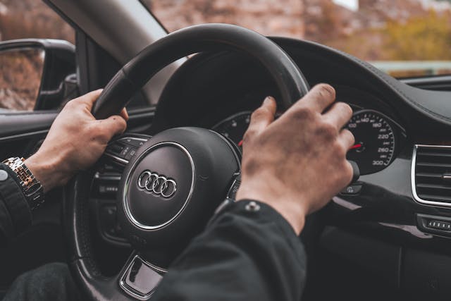 mans-hands-on-a-steering-wheel
