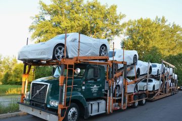 a-truck-with-a-car-on-the-back-of-it