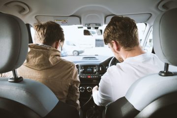 two-men-sitting-inside-vehicle
